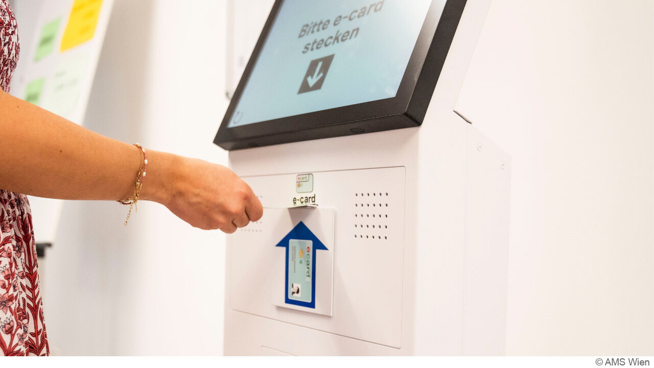 Person zeiht ein Ticket vom Ticketschalter